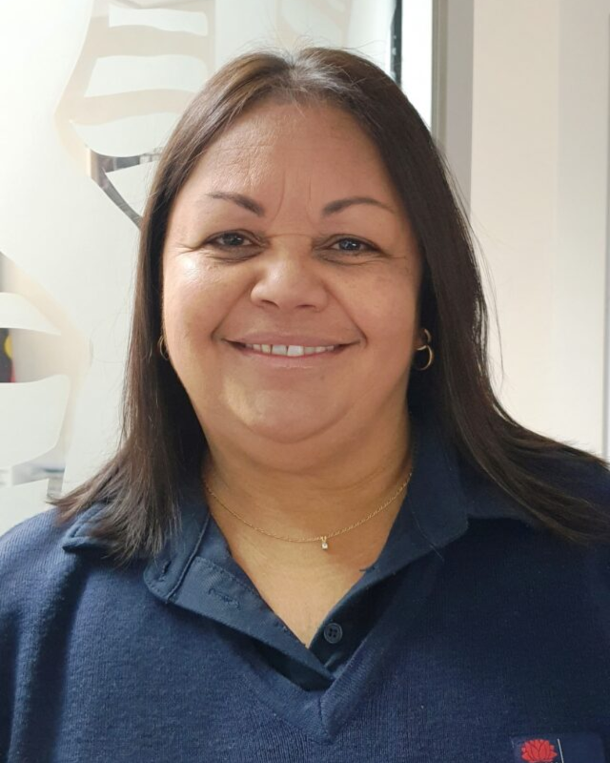 Mandy, who helps Aboriginal people connect with BreastScreen, is smiling.