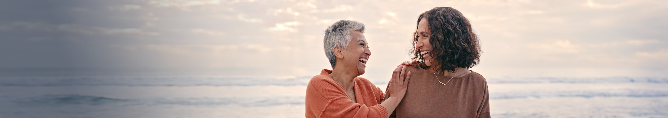 A banner of two happy women laughing.